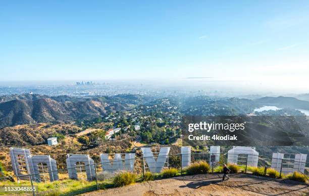 hollywood sign with los angeles in the background - hollywood entertainment district stock pictures, royalty-free photos & images