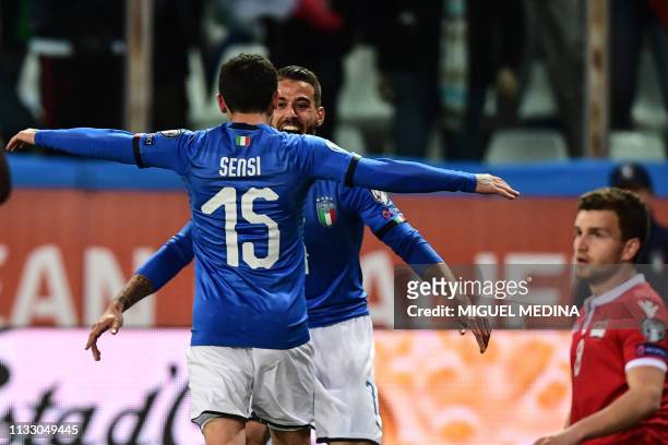 Italy's midfielder Stefano Sensi celebrates with Italy's defender Leonardo Spinazzola after scoring during the Euro 2020 Group J qualifying football...