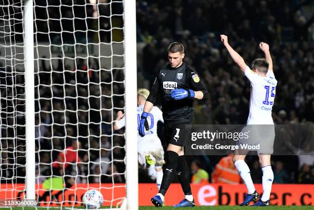 Goalkeeper Sam Johnstone of West Bromwich Albion stands dejected as Ezgjan Alioski of Leeds United runs of to celebrate scoring his sides fourth goal...