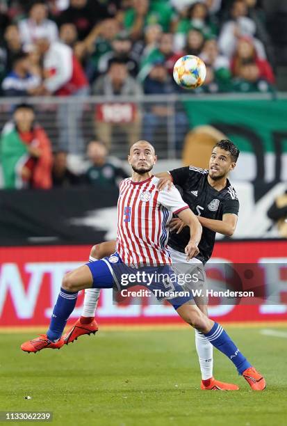 Diego Reyes of the Mexico National team battles for control of the ball with Carlos Gonzalez of Paraguay during the first half of their soccer game...