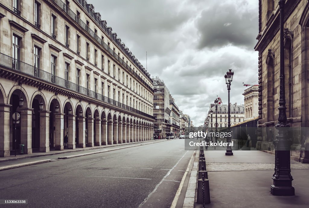 Empty Rue De Rivoli street against dramatic sky in Paris