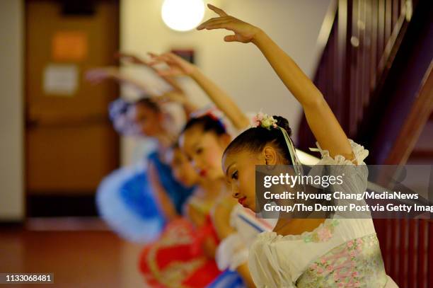 Thalia Miller front, and young dancers are warming up for the Pre-Competitive Contemporary Competition Ages 9-11 of the Youth America Grand Prix 20th...