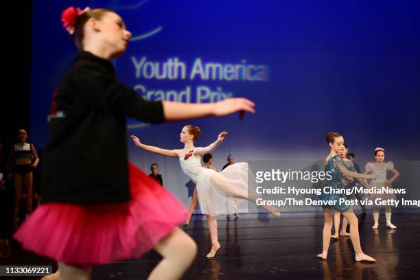 Young dancers are warming up during open stage pre-competitive contemporary Ages 9-11 of the Youth America Grand Prix 20th Anniversary Season's 2019...