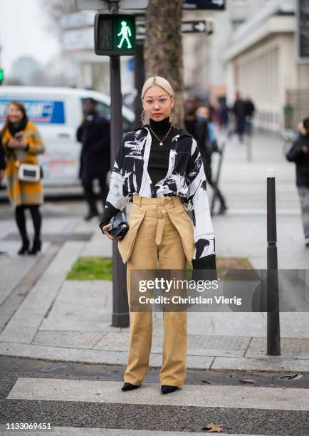 Vanesa Hong is seen weairng high waist beige pants outside Nina Ricci during Paris Fashion Week Womenswear Fall/Winter 2019/2020 on March 01, 2019 in...