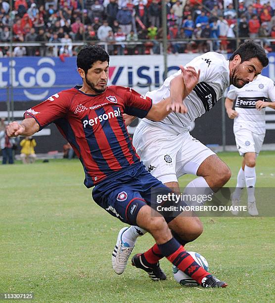 Olimpia player Juan Carlos Ferreyra fights for the ball against Pedro Benitez of Cerro Porteno, during a Paraguayan tournament football match held in...