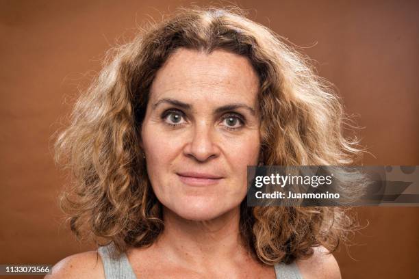 smiling mature caucasian woman looking at the camera - no make up stock pictures, royalty-free photos & images