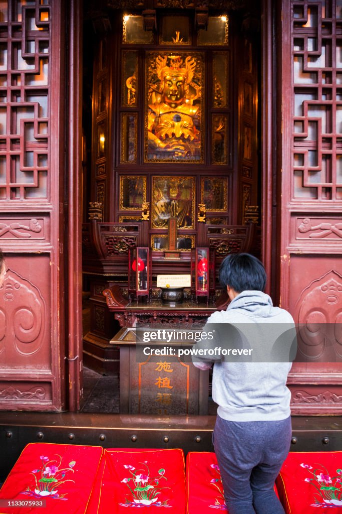 Man Praying at the Jade Buddha Temple in Shanghai, China