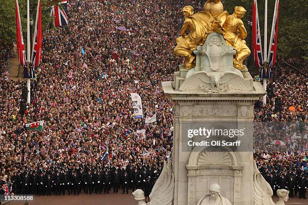Well wishers surge along the Mall behind the police towards Buckingham Palace to celebrate the Royal Wedding of Prince William, Duke of Cambridge and...