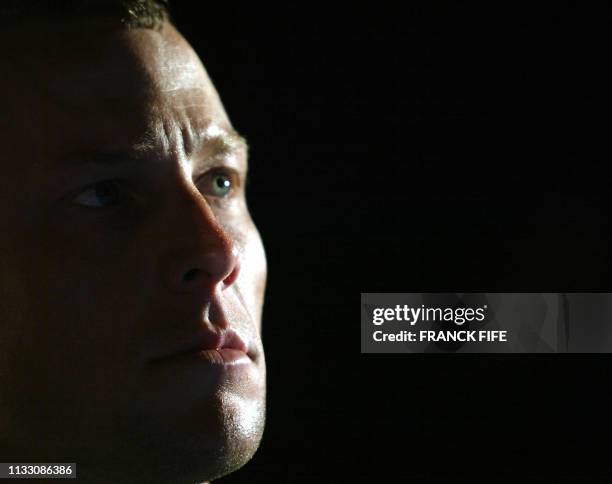 Rider Lance Armstrong speaks to the press 08 June 2003 in Villars de Lans, before the start of the 1st stage of the Critérium Dauphiné Libéré. AFP...