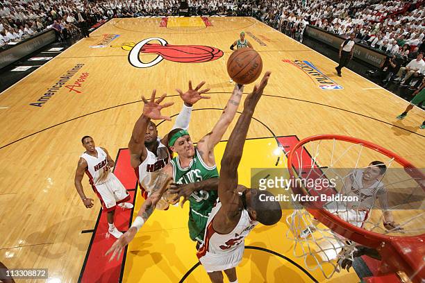Delonte West of the Boston Celtics dunks against Joel Anthony and Dwyane Wade of the Miami Heat in Game One of the Eastern Conference Semifinals in...