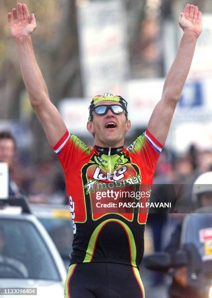 Le Français Jacky Durand lève les bras en signe de victoire, le 12 mars 1999, après avoir franchit la ligne d'arrivée de la 6e étape de la 66e...