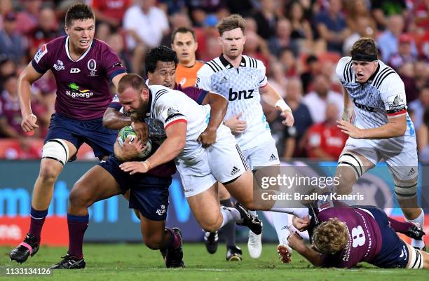 Joe Moody of the Crusaders takes on the defence during the round three Super Rugby match between the Reds and the Crusaders at Suncorp Stadium on...