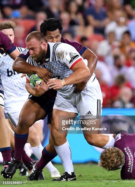 Joe Moody of the Crusaders takes on the defence during the round three Super Rugby match between the Reds and the Crusaders at Suncorp Stadium on...
