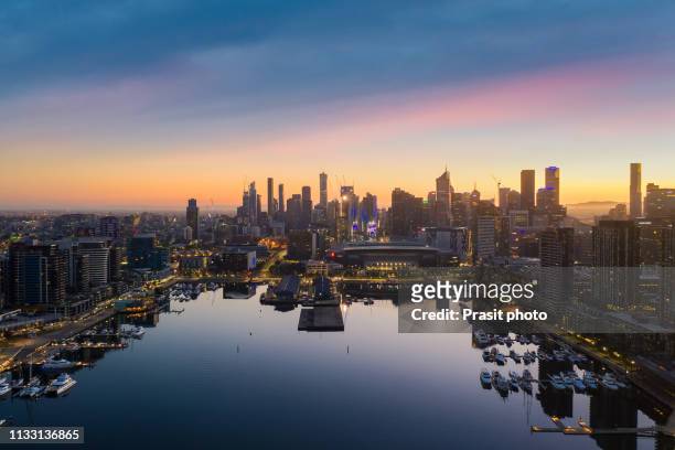 aerial view of docklands waterfront during sunrise in melbourne, victoria, australia. - boat melbourne stock-fotos und bilder