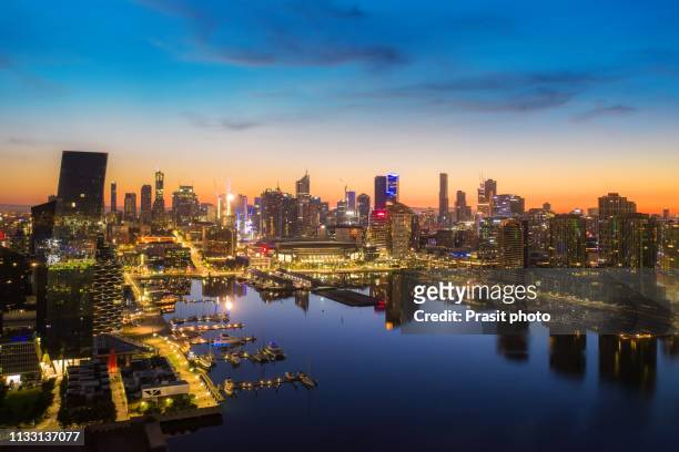 aerial view of docklands waterfront during sunrise in melbourne, victoria, australia. - docklands stadium melbourne stock pictures, royalty-free photos & images