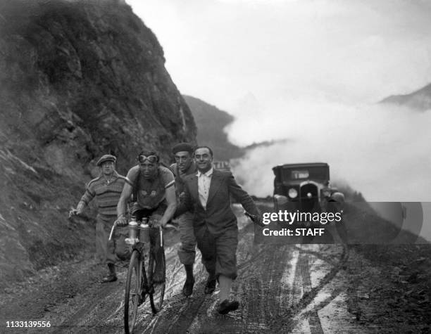 Le cycliste Julien Moineau est encouragé par Antonin Magne et Jean Bidot, le 12 juillet 1932 lors de la 5ème étape, Pau-Luchon, du Tour de France...