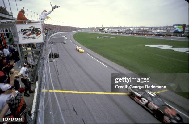 Daytona 500: Blurred view of Dale Earnhardt in action, crossing finish line winning race at Daytona International Speedway. Checkered flag. Daytona,...