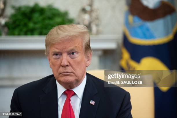 President Donald Trump speaks in the Oval Office of the White House in Washington, DC, March 27 during a meeting with Fabiana Rosales de Guaido, wife...