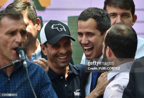 Venezuelan opposition leader and self-proclaimed interim president Juan Guaido shares a laugh with also opposition leader Henrique Capriles as they...