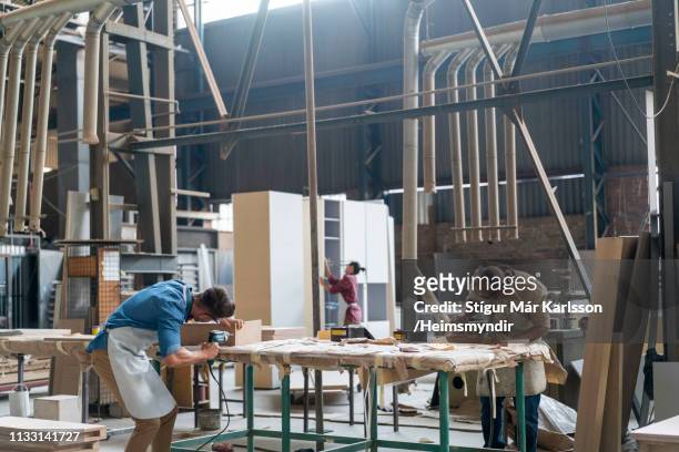 skilled carpenters making furniture in factory - furniture stock pictures, royalty-free photos & images