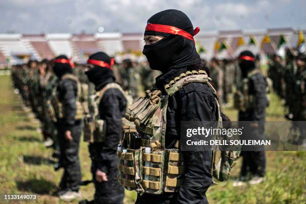 Fighters from the Kurdish Women's Protection units participate in a military parade on March 27 celebrating the total elimination of the Islamic...