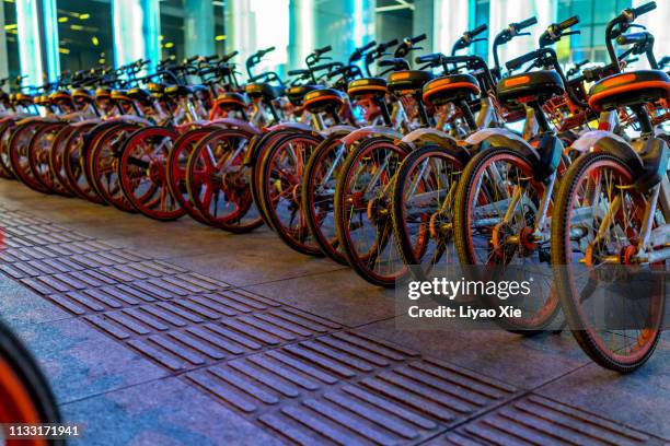 public rental bikes at shopping mall - bike sharing stock pictures, royalty-free photos & images