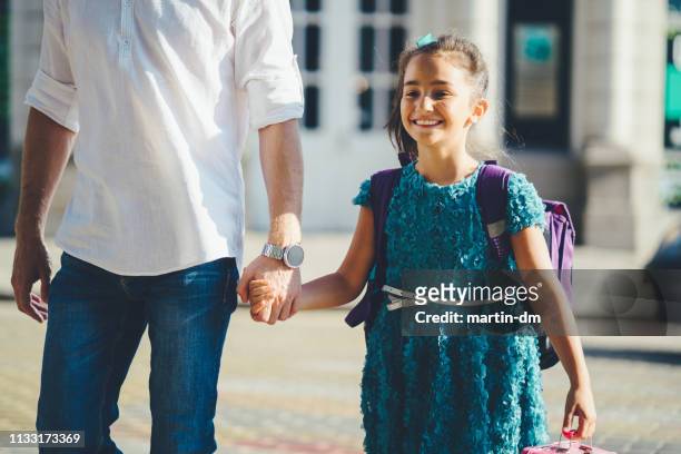 father leads his daughter to school - first day of summer stock pictures, royalty-free photos & images