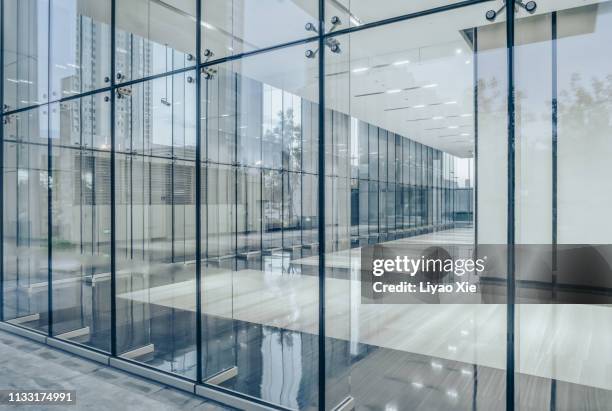 city skyline through office building - building lobby stock pictures, royalty-free photos & images