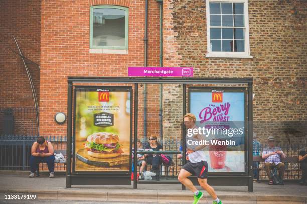 a local people jog - mcdonalds stock pictures, royalty-free photos & images