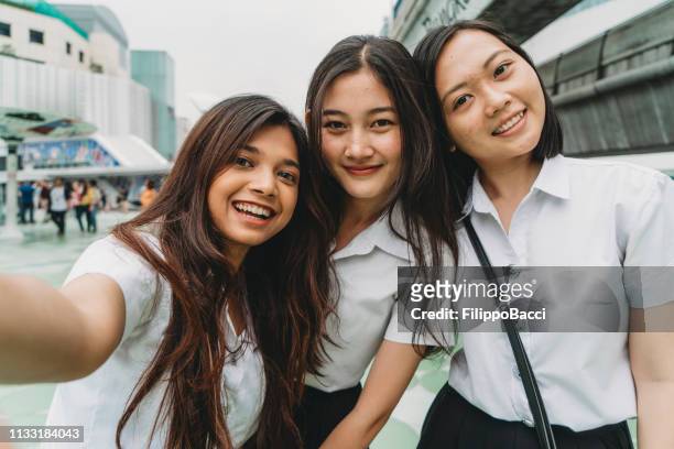 three student friends taking a selfie together in the city - cambodian ethnicity stock pictures, royalty-free photos & images