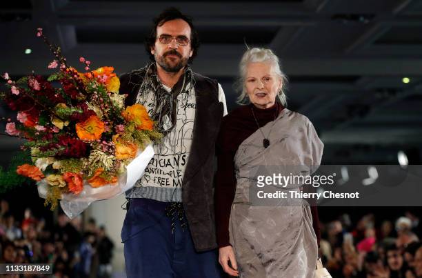 Austrian designer Andreas Kronthaler and British designer Vivienne Westwood acknowledge the audience at the end of the Vivienne Westwood show as part...