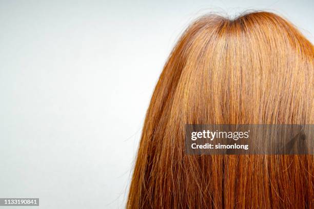 close up of copper blond hair against white background - shiny hair back stock pictures, royalty-free photos & images