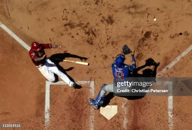 Ryan Roberts of the Arizona Diamondbacks safely slides in to score a run past catcher Geovany Soto of the Chicago Cubs during the fourth inning of...