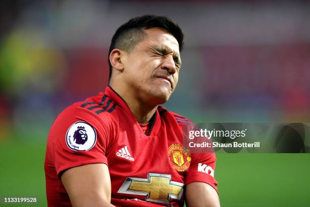 Alexis Sanchez of Manchester United reacts with an injury during the Premier League match between Manchester United and Southampton FC at Old...