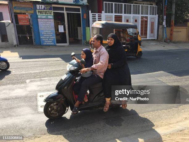 Man travels with his wife and daughter on a scooter in the city of Thiruvananthapuram , Kerala.