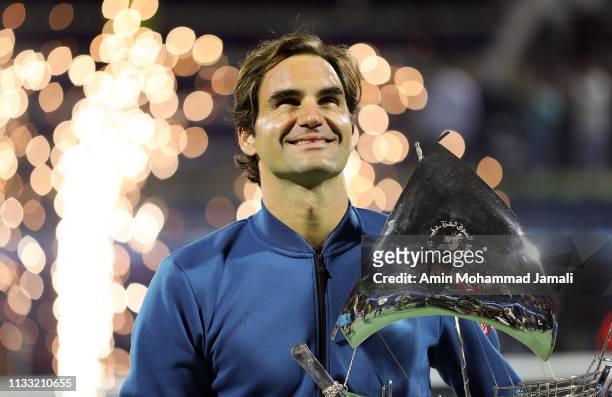 Roger Federer of Switzerland poses with his trophy after defeating Stefanos Tsitsipas of Greece in their final match day Fourteen of the Dubai Duty...