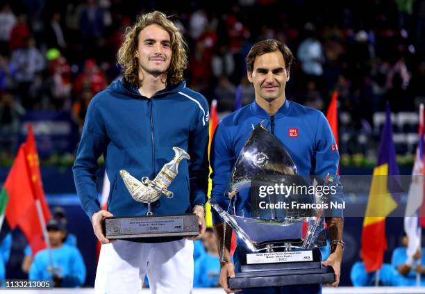 Stefanos Tsitsipas of Greece, runner up and Roger Federer of Switzerland, winner pose with their trophies after the Dubai Duty Free Championships at...