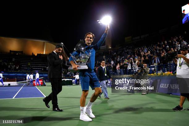 Roger Federer of Switzerland poses with the winners trophy after victory during day fourteen of the Dubai Duty Free Championships at Tennis Stadium...
