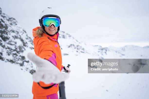 happy skiing woman inviting you - following behind stock pictures, royalty-free photos & images