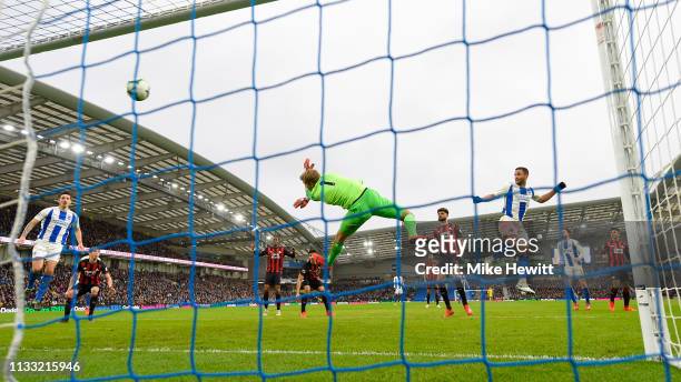 Florin Andone of Brighton & Hove Albion heads past Jonas Lossl of Huddersfield Town for the only goal of the game during the Premier League match...