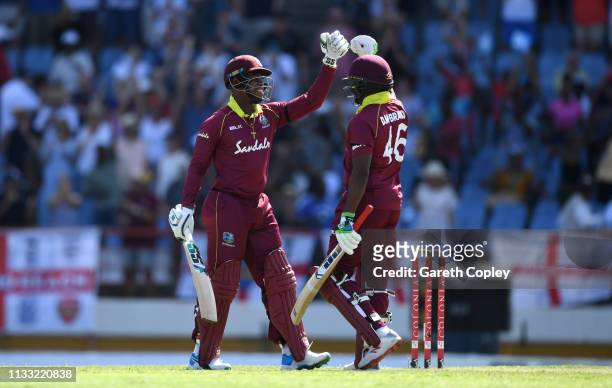 Shimron Hetmyer and Darren Bravo of the West Indies celebrate winning the Fifth One Day International match between England and West Indies at Darren...