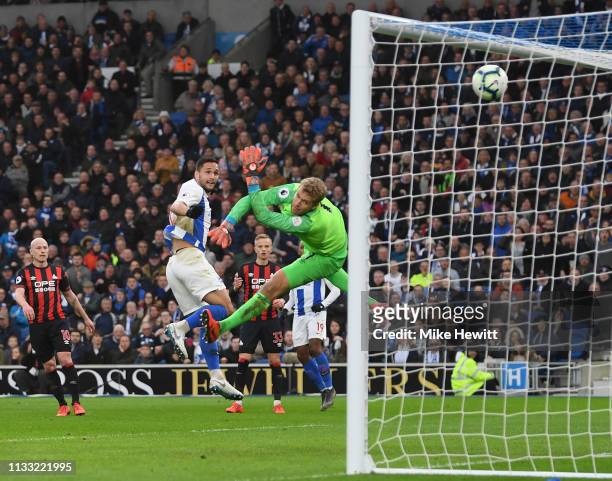 Florin Andone of Brighton & Hove Albion heads past Jonas Lossl of Huddersfield Town for the only goal of the game during the Premier League match...