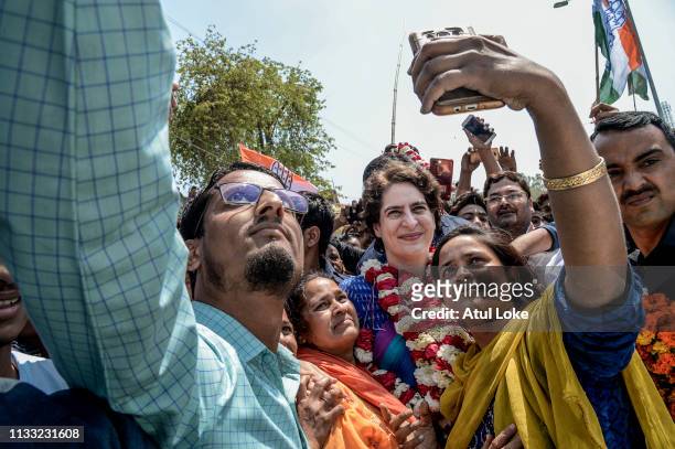 Young women pose for a selfie with Congress Party's Priyanka Gandhi during her campaign on March 27, 2019 in Uttar Pradesh, India. Congress leader...