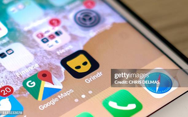 This picture taken on March 27, 2019 shows the Grindr app on a phone in Los Angeles. - A Chinese firm has been ordered by American national security...