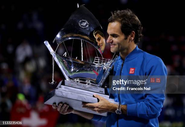 Roger Federer of Switzerland poses with the winners trophy after victory during day fourteen of the Dubai Duty Free Championships at Dubai Tennis...