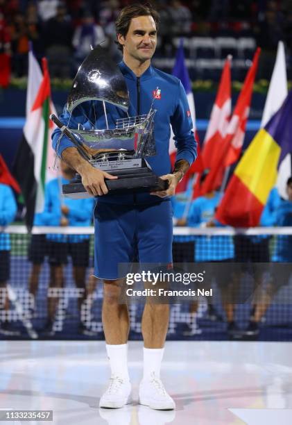 Roger Federer of Switzerland poses with the winners trophy after victory during day fourteen of the Dubai Duty Free Championships at Dubai Tennis...