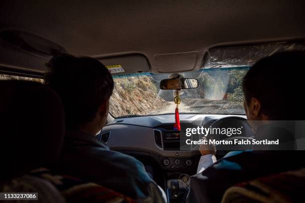 a local driver and guide driving a car in trongsa, bhutan - car stereo stock pictures, royalty-free photos & images