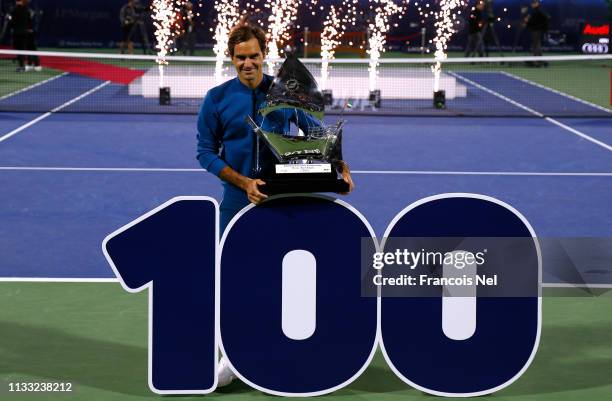 Roger Federer of Switzerland poses with the winners trophy after victory during day fourteen of the Dubai Duty Free Championships at Tennis Stadium...