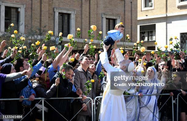 Actor John Malkovich, dressed as pope, lifts a baby during the filming of "The new Pope", the sequel of Paolo Sorrentino's movie "The young Pope", in...