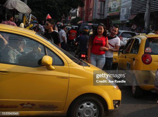 People pass through the streets of a shopping district as the city deals with the influx of Venezuelans that are crossing the border on March 2, 2019...